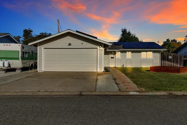 a front view of a house with a yard and garage