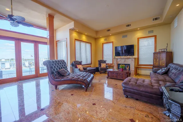 a living room with furniture fireplace and a large window