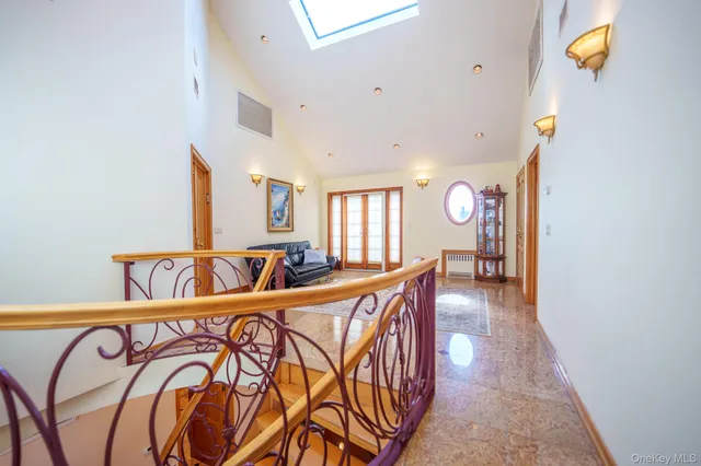 a view of a hallway with wooden floor and furniture