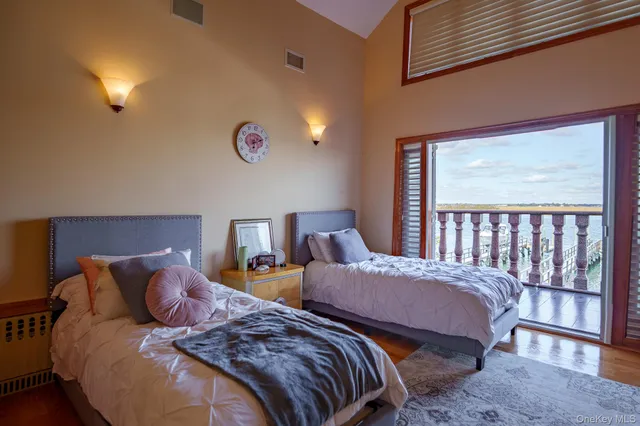 a bedroom with two beds and a window