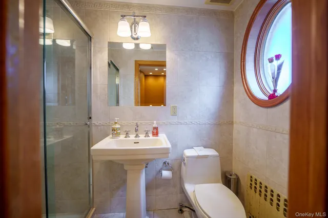 a bathroom with a sink toilet and shower