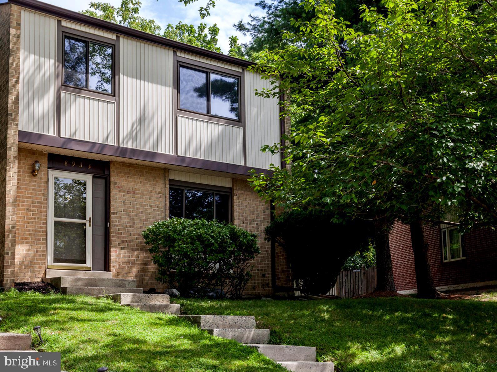 8933 Centerway Road Gaithersburg, MD 20879 - Photo 1 of 29 a view of a house with brick walls and a yard with plants