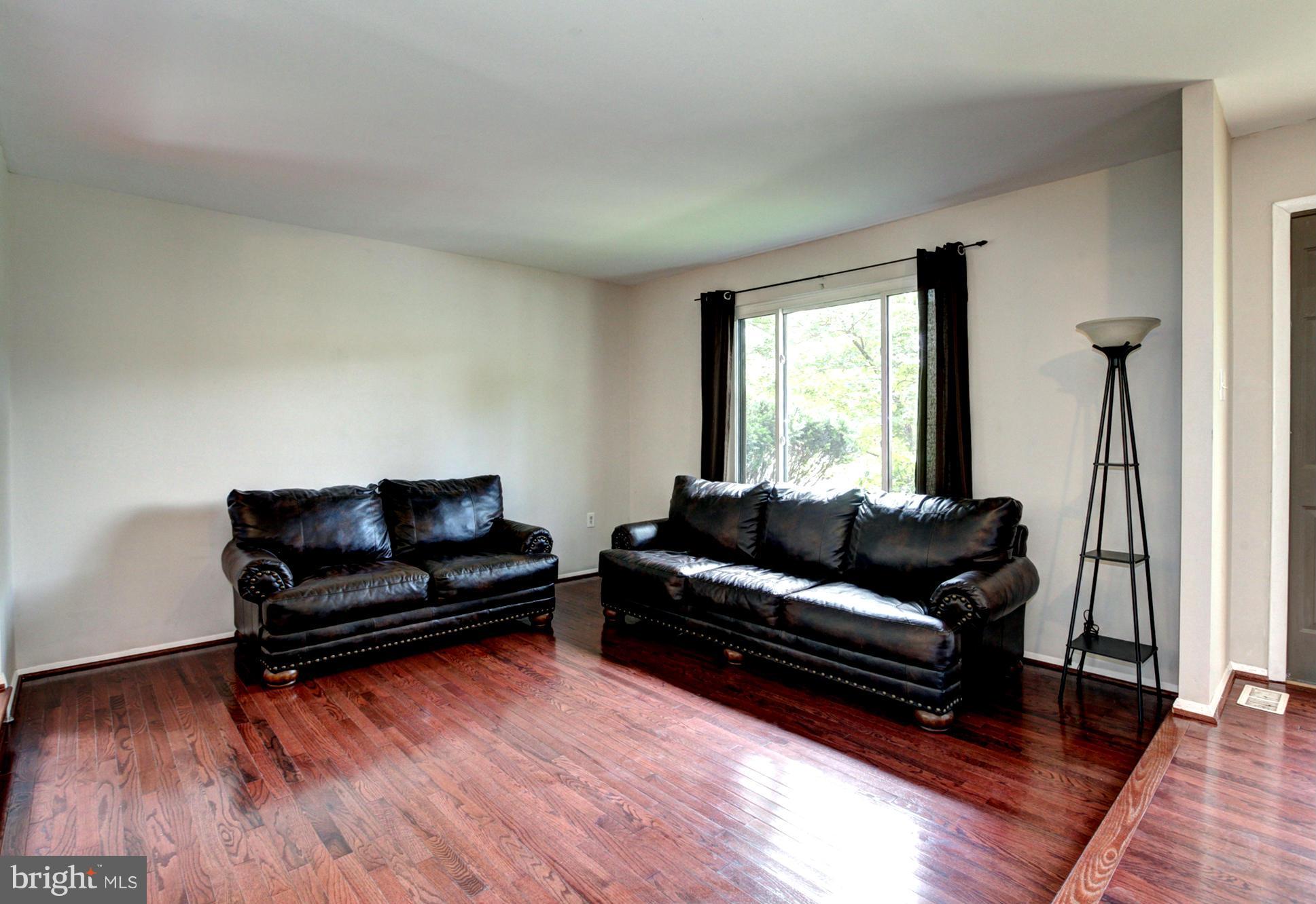 8933 Centerway Road Gaithersburg, MD 20879 - Photo 11 of 29 a living room with furniture and a wooden floor
