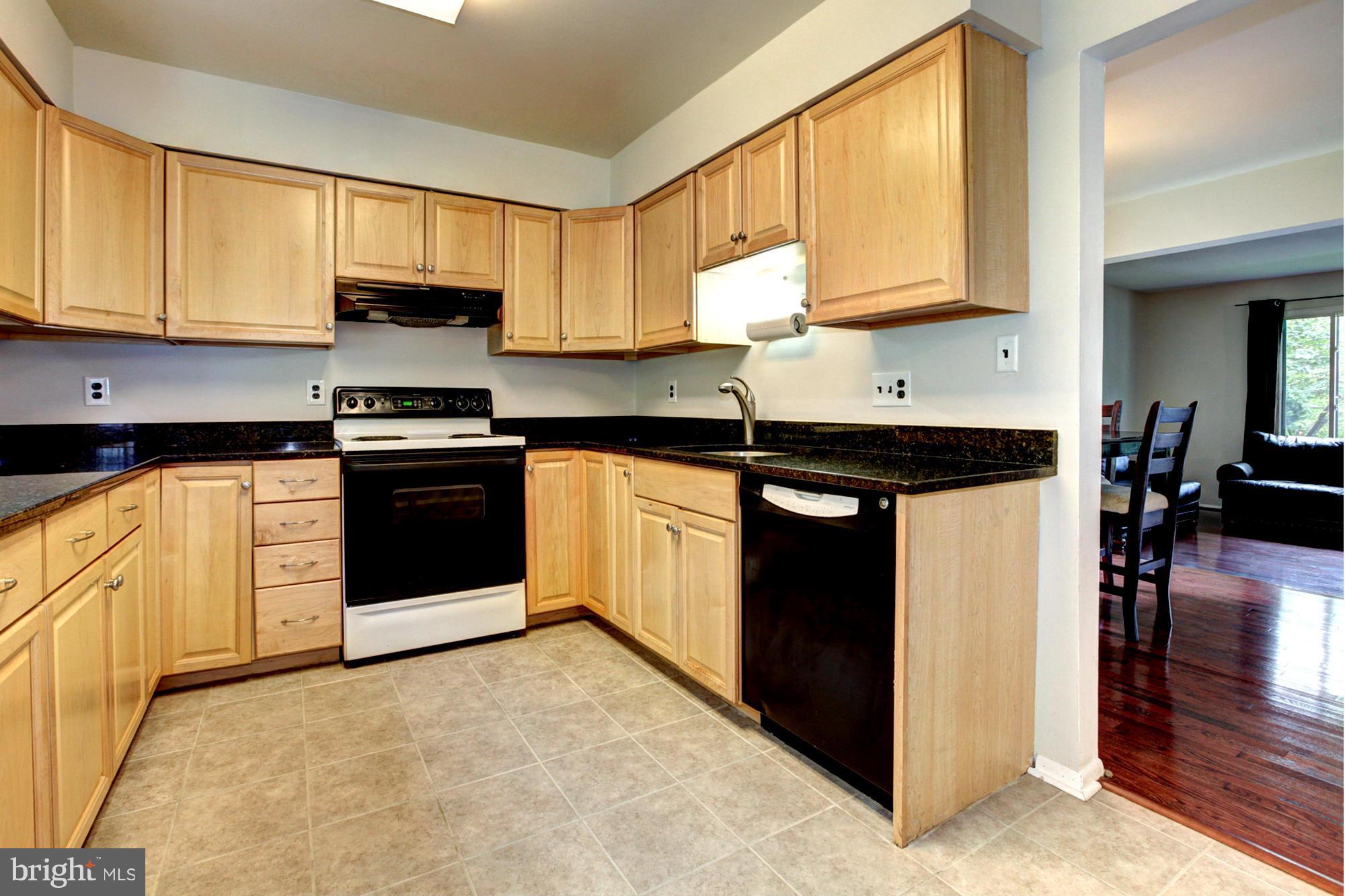 8933 Centerway Road Gaithersburg, MD 20879 - Photo 13 of 29 a kitchen with stainless steel appliances granite countertop a stove a sink and a microwave