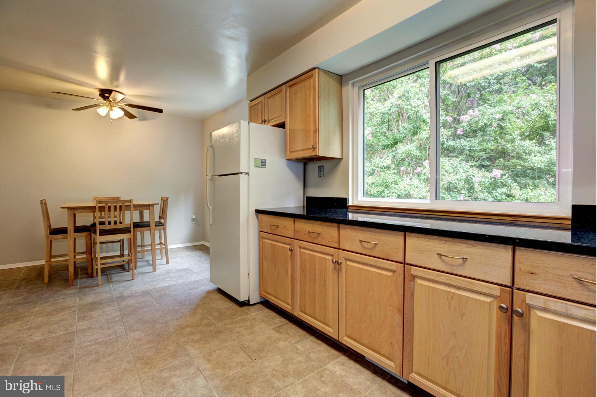 8933 Centerway Road Gaithersburg, MD 20879 - Photo 14 of 29 a kitchen with stainless steel appliances granite countertop a refrigerator a sink a stove and white cabinets