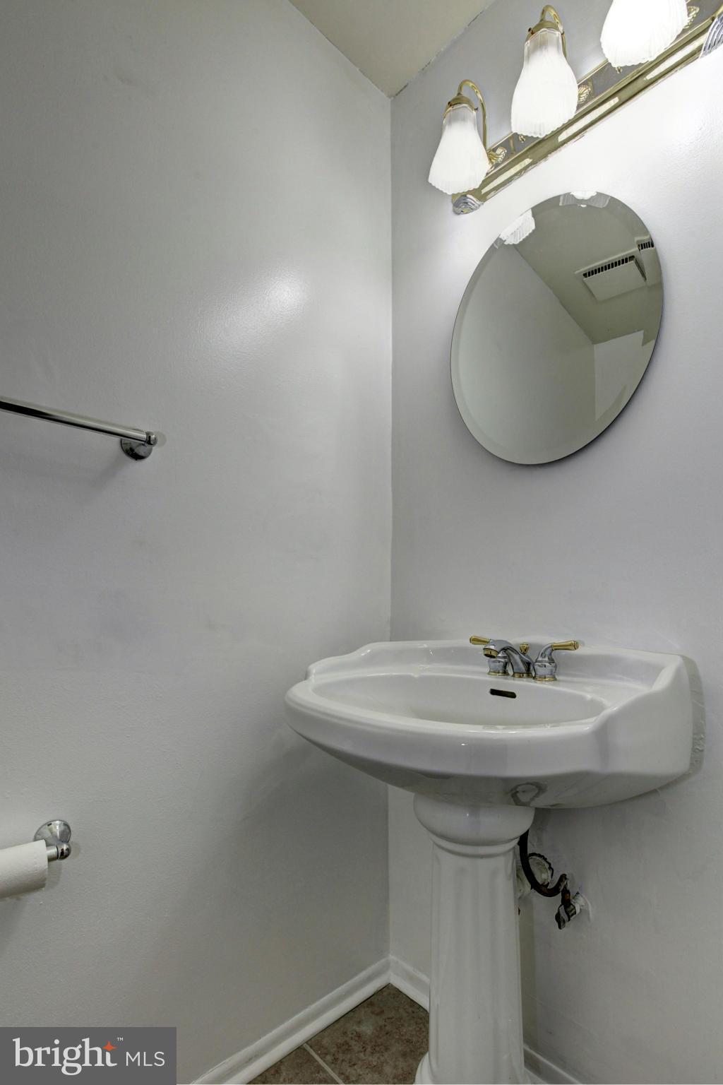 8933 Centerway Road Gaithersburg, MD 20879 - Photo 16 of 29 a bathroom with a sink a vanity and a mirror