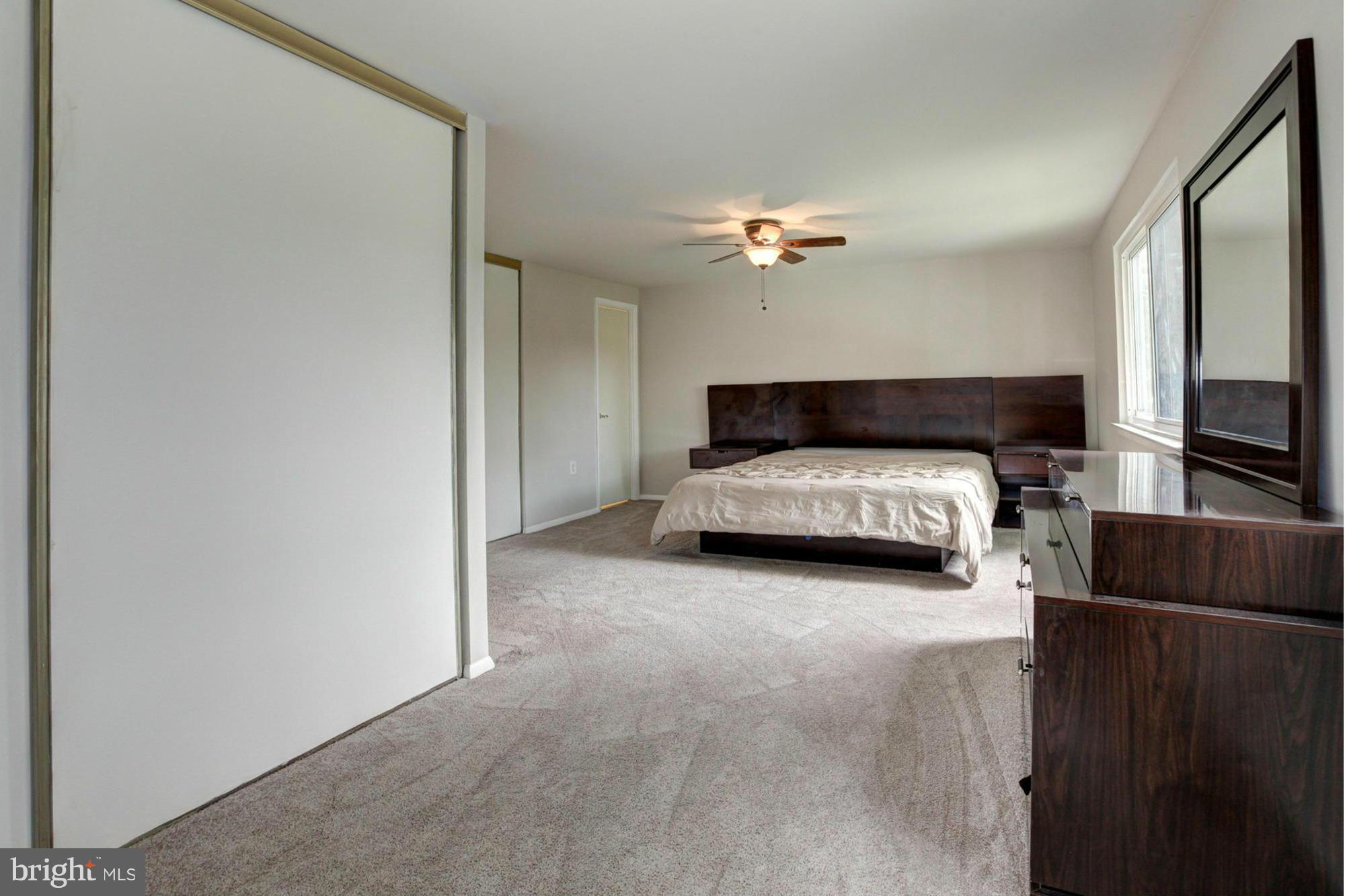 8933 Centerway Road Gaithersburg, MD 20879 - Photo 18 of 29 a bedroom with a bed window and couch