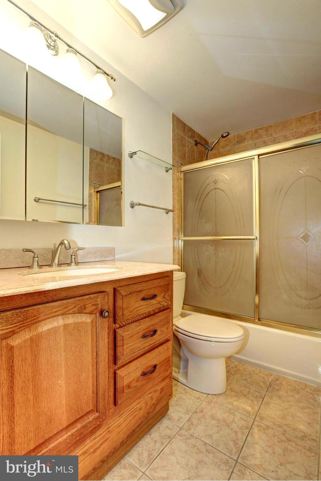 8933 Centerway Road Gaithersburg, MD 20879 - Photo 21 of 29 a bathroom with a sink a toilet and shower