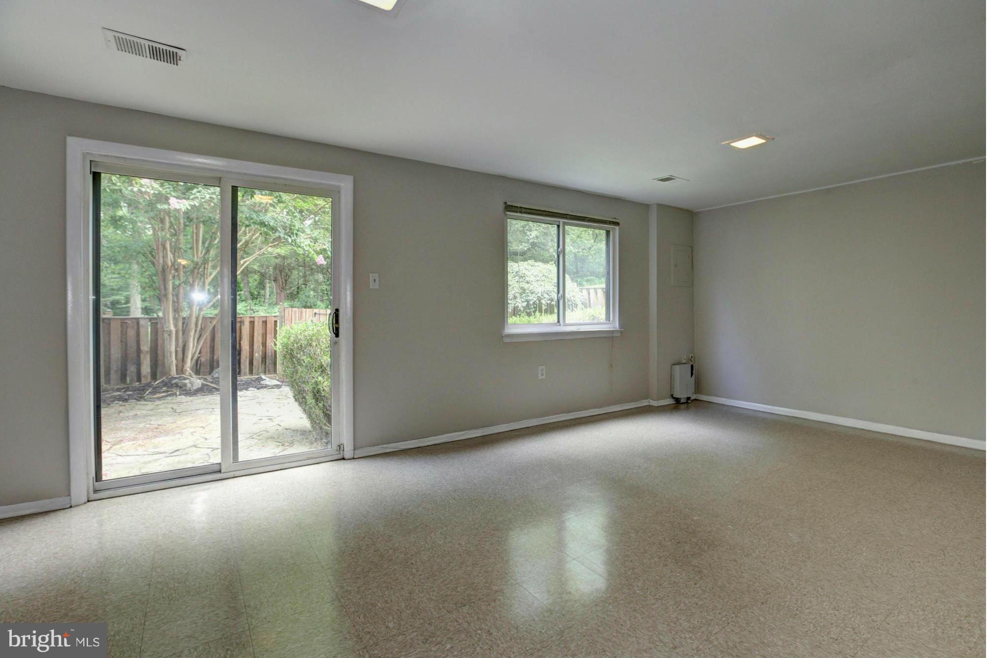 8933 Centerway Road Gaithersburg, MD 20879 - Photo 25 of 29 a view of an empty room with wooden floor and a window