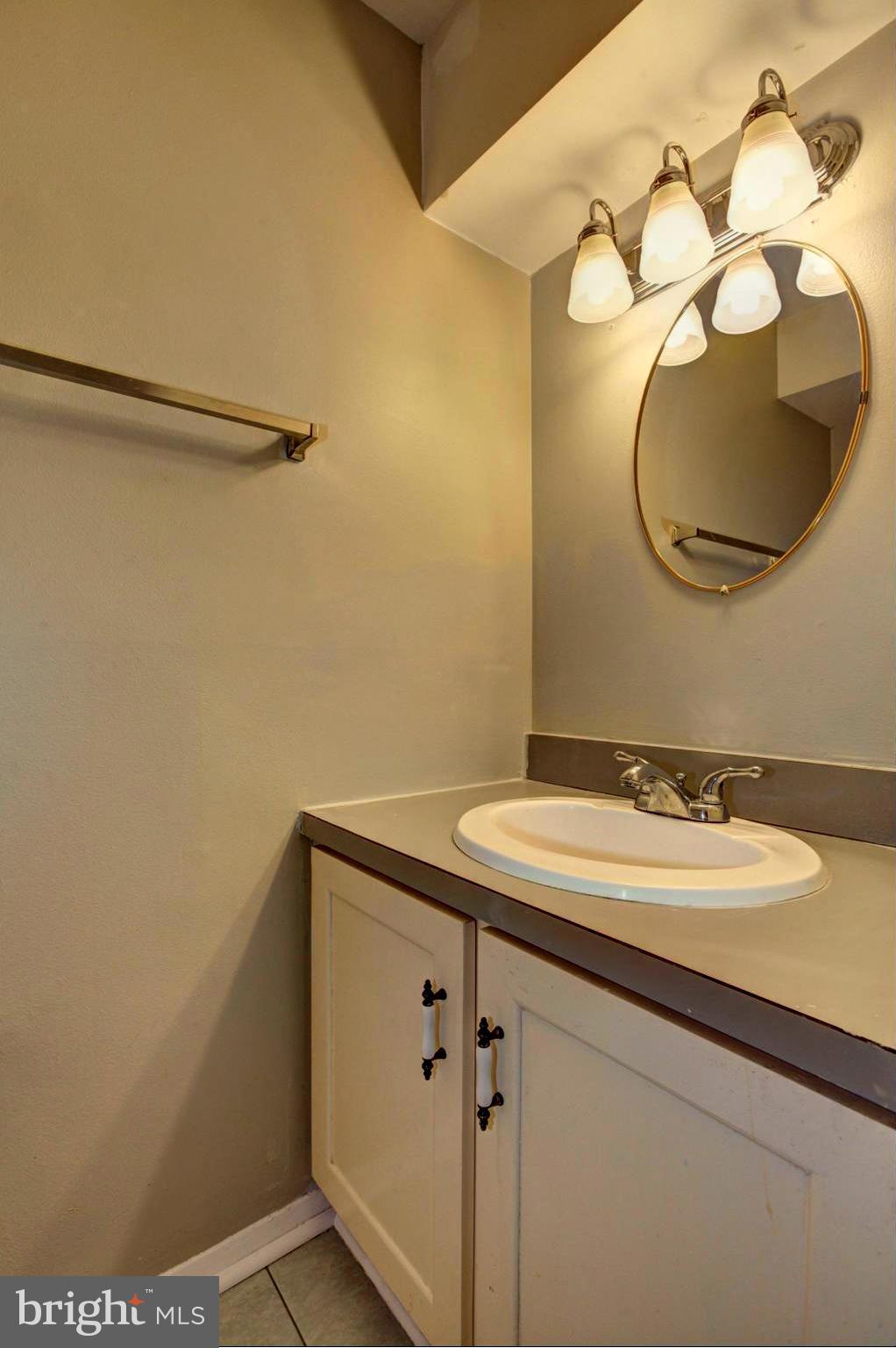 8933 Centerway Road Gaithersburg, MD 20879 - Photo 27 of 29 a bathroom with a sink and a mirror