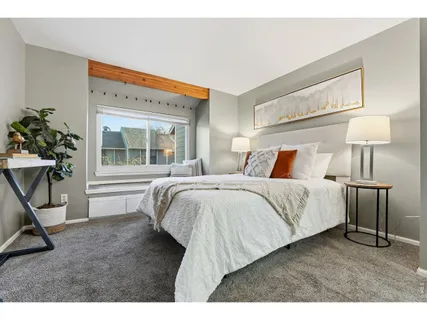 a bedroom with a bed and a mirror