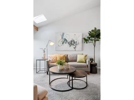 a living room with furniture and a lamp