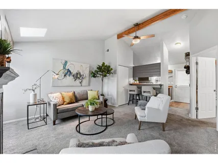 a living room with furniture potted plant and a mirror