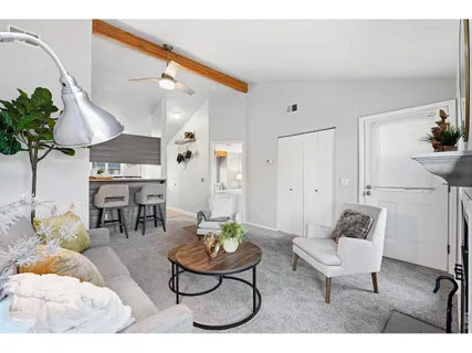 a kitchen with stainless steel appliances kitchen island a table chairs in it and wooden floor