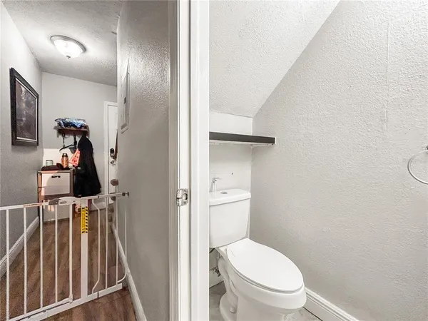 a view of hallway with wooden floor and stairs