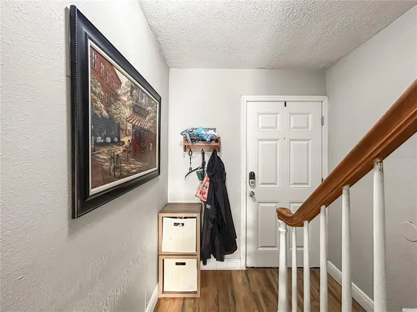 a living room with furniture a flat screen tv and a wooden floor