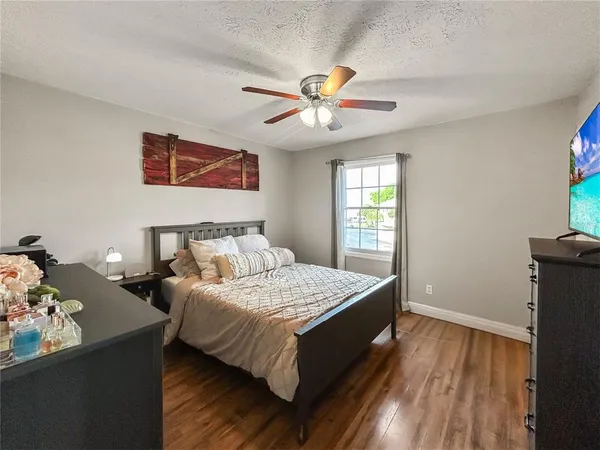 a bedroom with a bed and a chandelier
