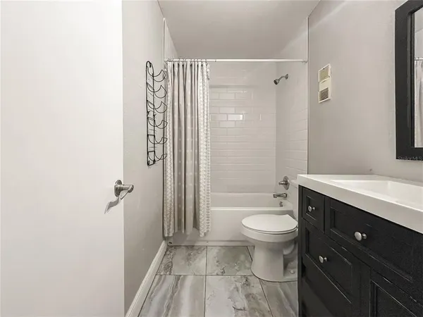 a view of a patio with couple of chairs and a fountain