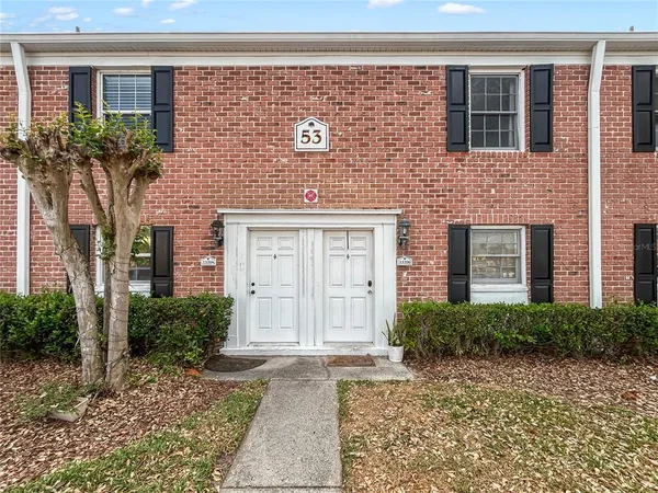 a front view of residential houses with yard
