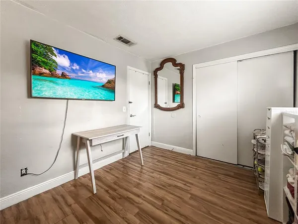 a view of an empty room with furniture and a book shelf
