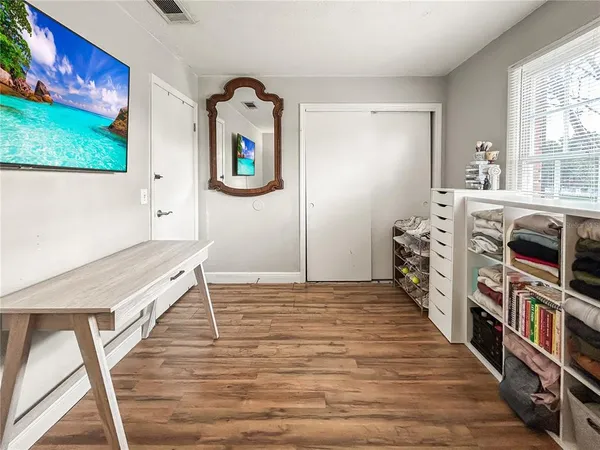 a living room with furniture and a wooden floor