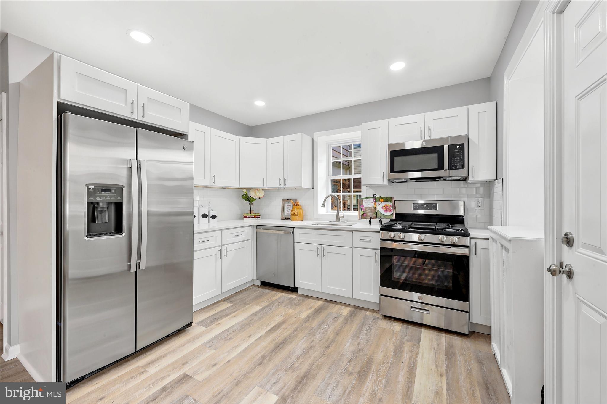7208 Hilltop Road Upper Darby, PA 19082 - Photo 13 of 28 a kitchen with stainless steel appliances a refrigerator sink and microwave
