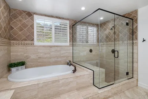 a white bath tub sitting next to a shower