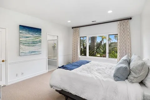 a bedroom with a large bed and a large window