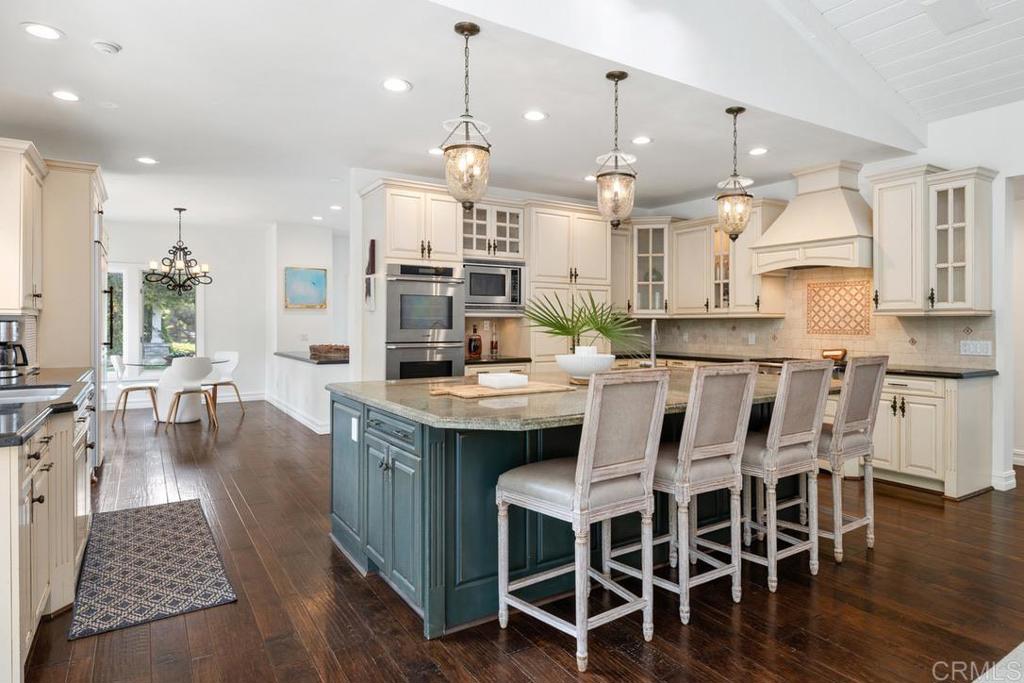4715 La Noria Rancho Santa Fe, CA 92067 - Photo 4 of 26 a large kitchen with a table and chairs