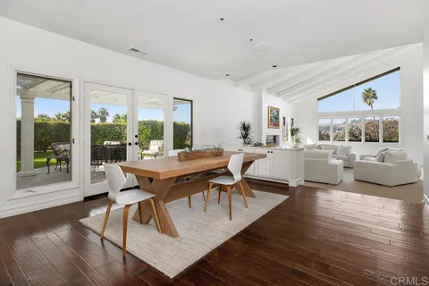 a living room with furniture a table and a large window
