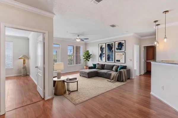 a living room with furniture and a wooden floor