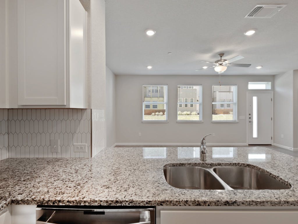 9015 Cattle Baron Path, Unit 2003 Austin, TX 78747 - Photo 11 of 31 a kitchen with granite countertop a sink and granite top