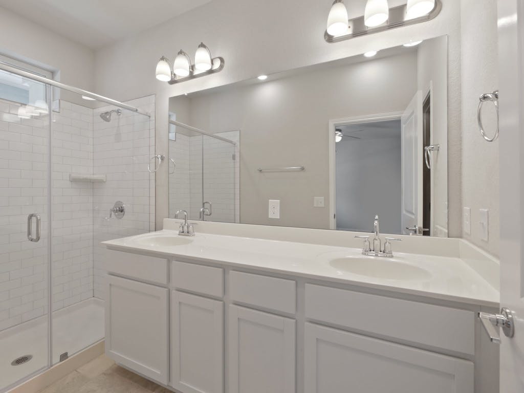9015 Cattle Baron Path, Unit 2003 Austin, TX 78747 - Photo 14 of 31 a bathroom with double vanity sink and a mirror