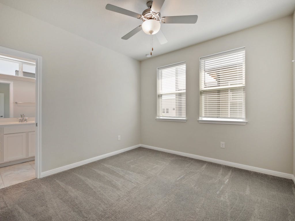9015 Cattle Baron Path, Unit 2003 Austin, TX 78747 - Photo 18 of 31 an empty room with windows and fan