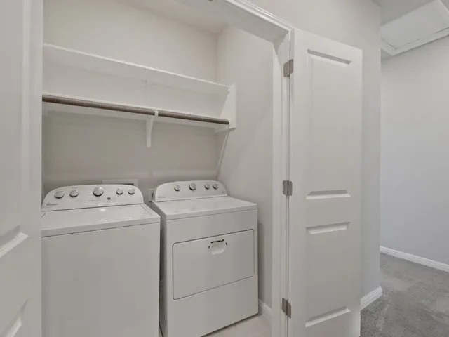a view of storage and utility room with washer and dryer