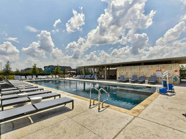 a view of a swimming pool with lounge chairs