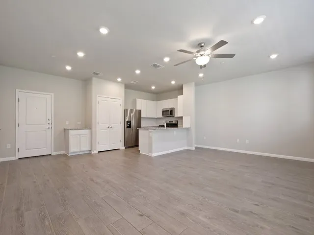 a view of a kitchen with a sink and a refrigerator