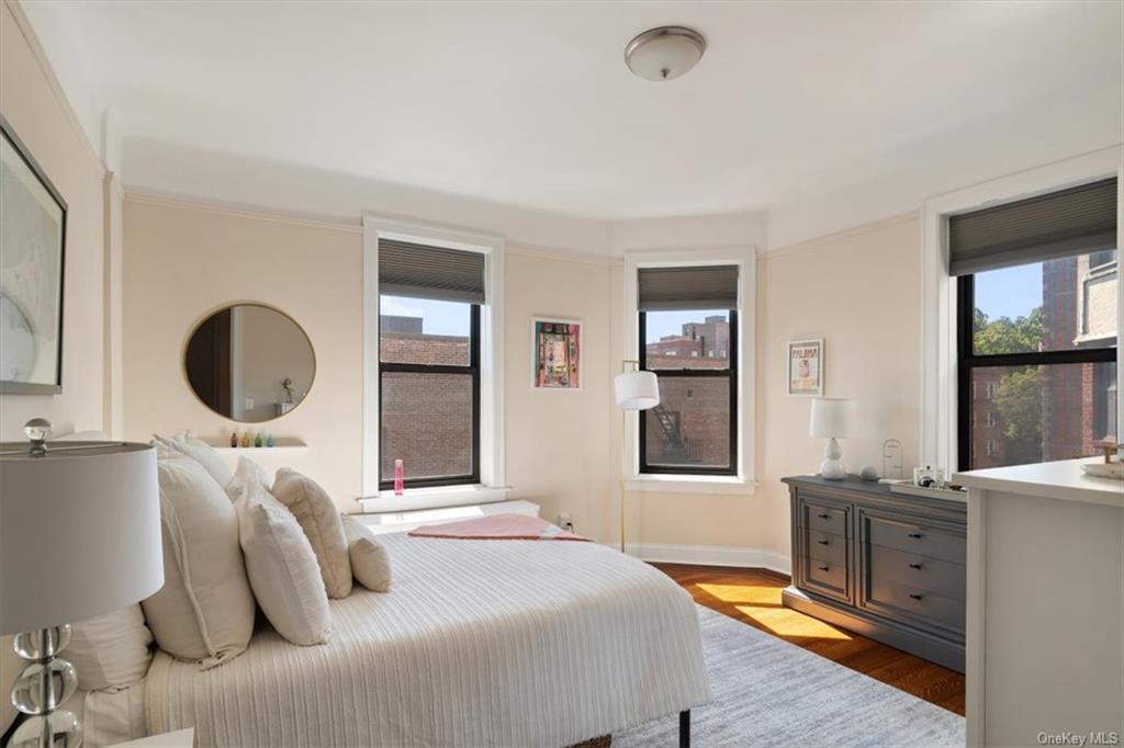 31 Pondfield Road, Unit 46 Bronxville, NY 10708 - Photo 2 of 15 a bedroom with a bed and dresser with mirror