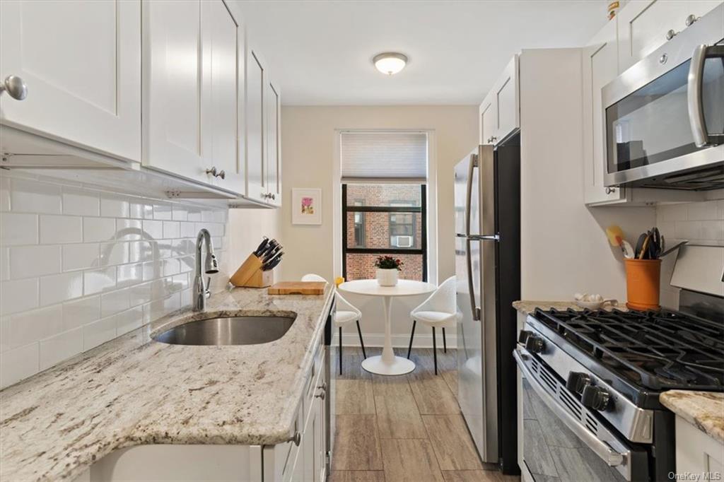 31 Pondfield Road, Unit 46 Bronxville, NY 10708 - Photo 9 of 15 a kitchen with furniture wooden floor and stainless steel appliances