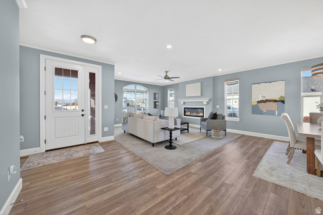 1222 West 190th Street North Mapleton, UT 84664 - Photo 3 of 46 Open-concept living space featuring wood-finish flooring, a contemporary fireplace with a white mantel, and recessed lighting