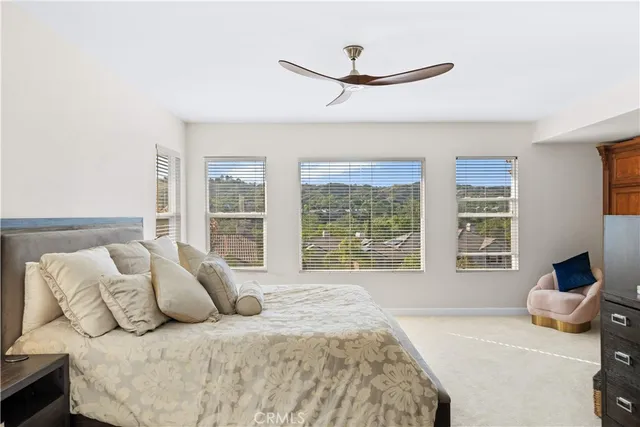 a spacious bedroom with a bed and a large window