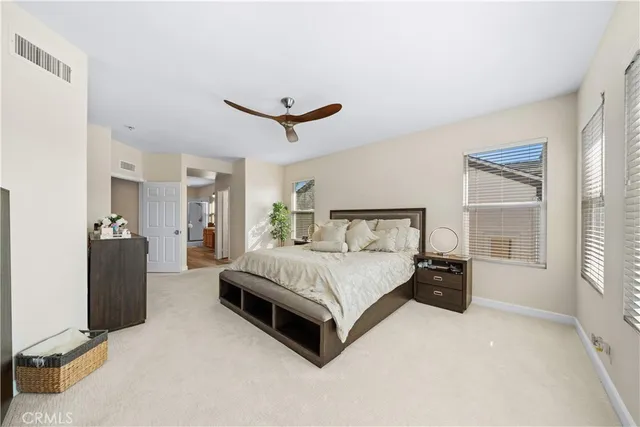 a bedroom with a bed and a large mirror