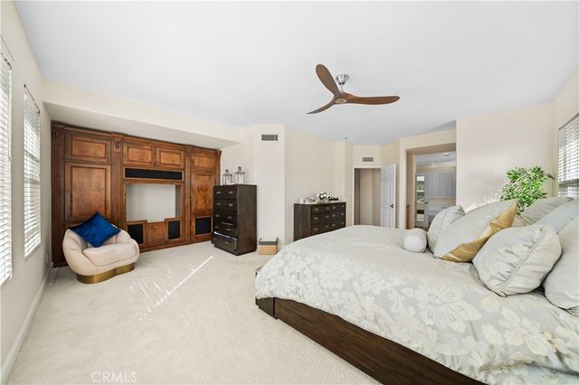 a bedroom with a large bed and a potted plant