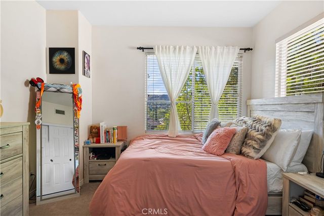 a bathroom with a toilet a sink a mirror a shower and vanity
