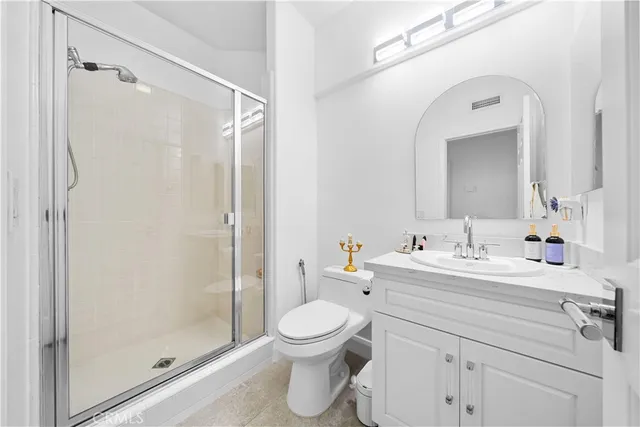 a bathroom with a double vanity sink toilet and shower