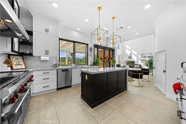 a kitchen with a sink counter top space appliances and a window