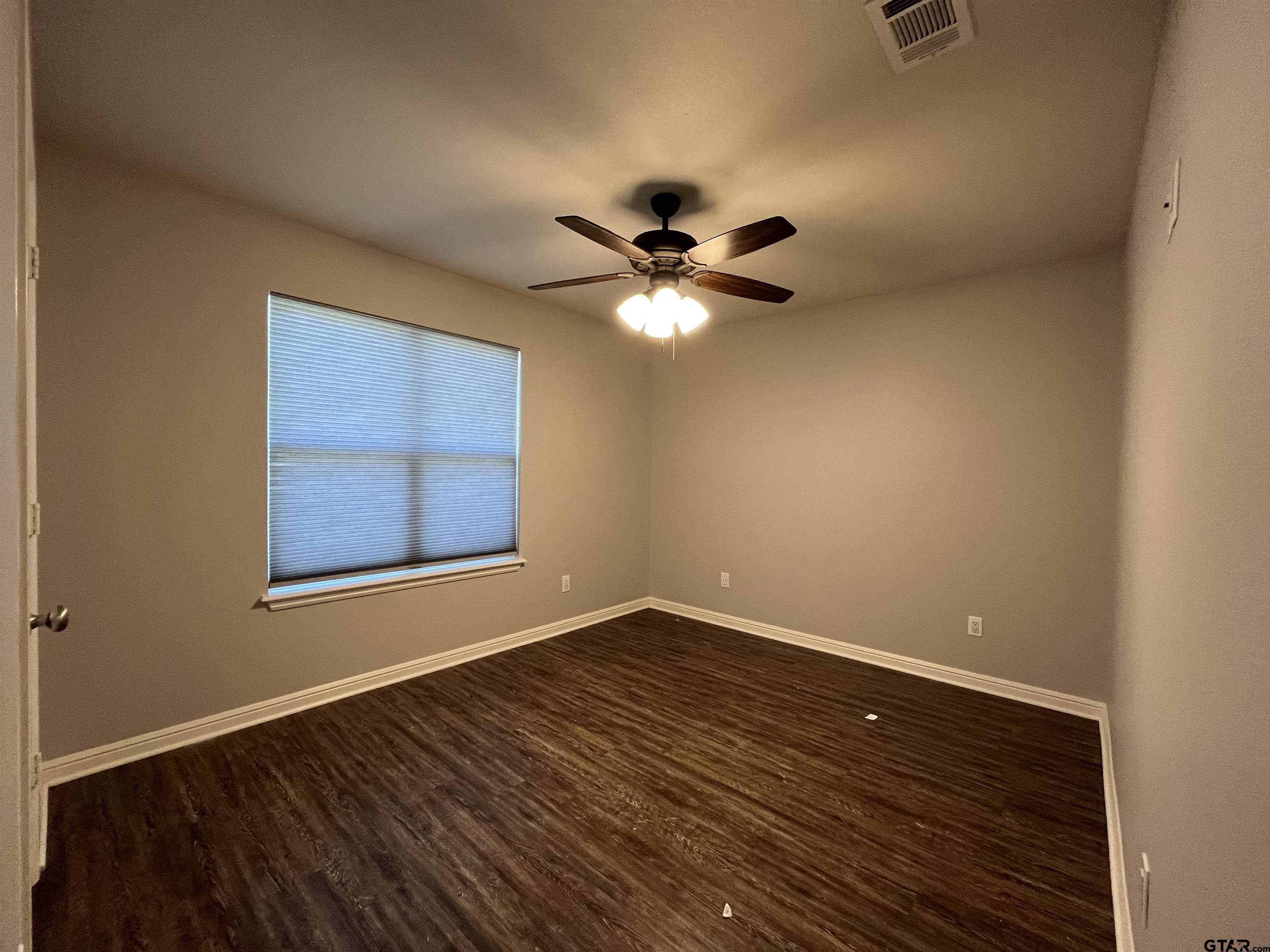 5429 Meadow Ridge Drive Flint, TX 75762 - Photo 12 of 24 a view of an empty room with a window and a ceiling fan