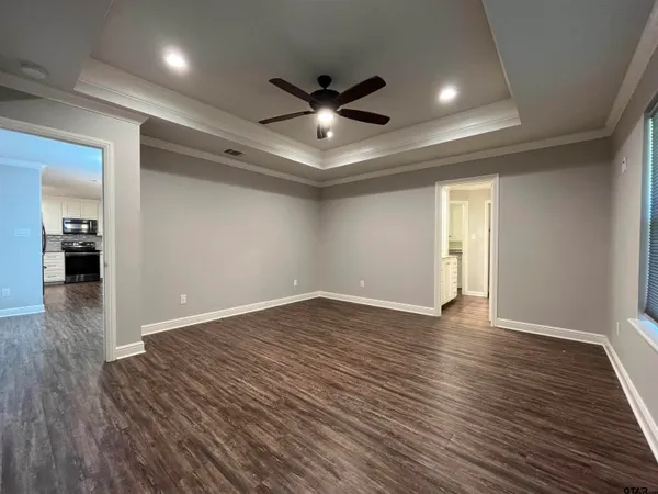a view of an empty room with wooden floor