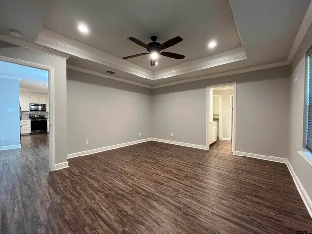 a view of an empty room with wooden floor