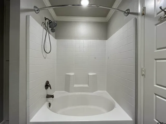 a bathroom with a tub and shower